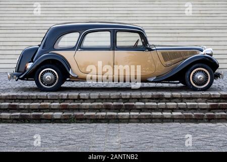 Vintage French Car in two toned black and gold isolated in Palatial setting on a grand staircase. a nostalgic image of the end of French Colonialism Stock Photo
