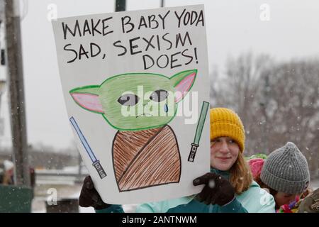 Philadelphia, PA, USA - January 18, 2020: A woman holds up a protest sign featuring Baby Yoda at the fourth annual Women's March on Philadelphia. Stock Photo