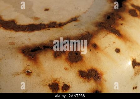a lot of rust spots and holes on the enamel Stock Photo