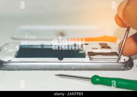 Android Phone repairs for smartphone By professional technician on desk. Stock Photo