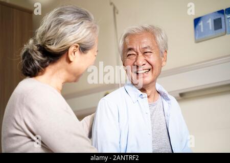 happy asian senior couple talking in hospital ward Stock Photo