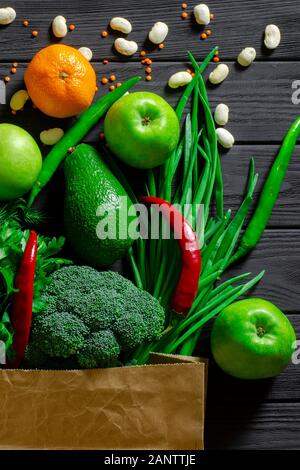 Healthy food clean eating selection: fruit, vegetable, seeds, superfood, cereals, leaf vegetable on gray concrete background Stock Photo