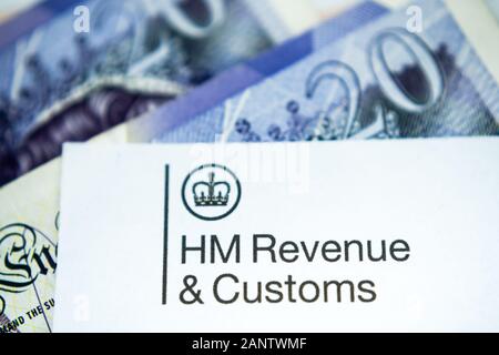 HMRC letter with HM Revenue & Customs logo placed on top of 20 pound notes. Close up photo with selective focus. Stock Photo