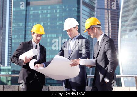 Engineering and architecture concept, engineers working on a building site holding blueprints , architects and engineers inspection in workplace for a Stock Photo