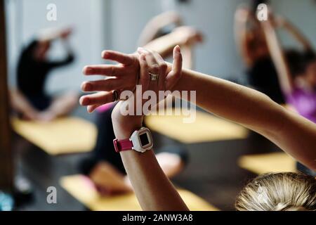 yoga class young overweight woman exercising practicing poses stretching body enjoying healthy weight loss lifestyle in fitness studio Stock Photo