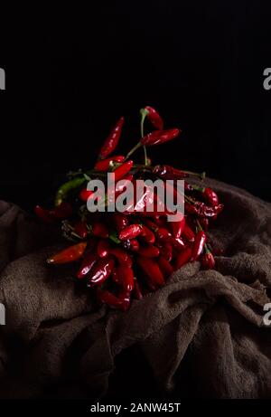 Still life with dry chilli peppers in dark mood Stock Photo