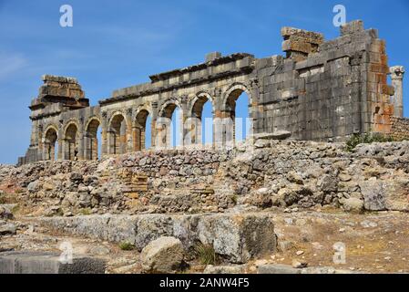 The ruined Basilica, a Roman excavation in the ancient Berber town of Volubilis, close to the city of Meknes, Morocco, North Africa. Stock Photo