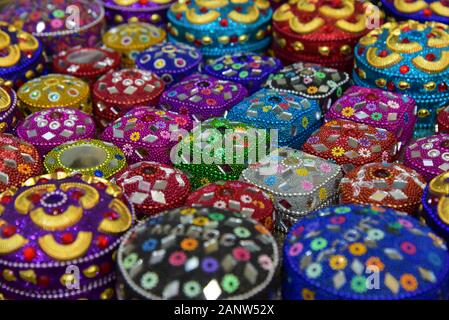 Small brightly coloured decorative trinket boxes on sale in a Moroccan souvenir shop, North Africa. Stock Photo
