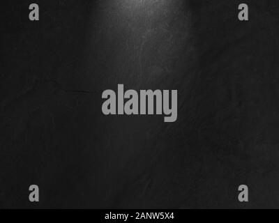 Slate stone background with dark corners and a light pointing from the top to the middle of the background. Stock Photo