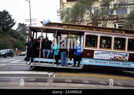 Crowded Cable Car passes the famous Lombard Street in San Francisco, USA Stock Photo