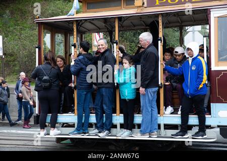 Crowded Cable Car passes the famous Lombard Street in San Francisco, USA Stock Photo