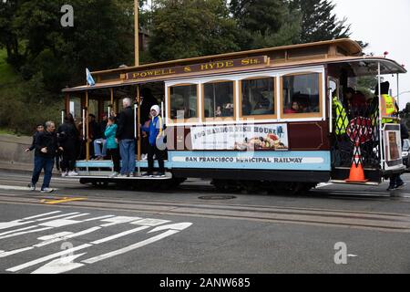 Crowded Cable Car passes the famous Lombard Street in San Francisco, USA Stock Photo