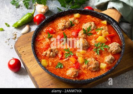 Spanish and Mexican food - Albondigas. Hot stew tomato soup with meatballs and vegetables. Stock Photo