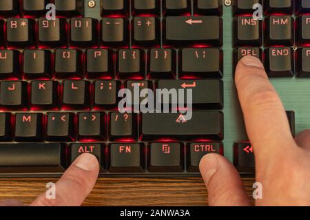 keyboard shortcut ctrl alt del is pressed with a male hand Stock Photo
