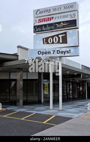 A tall retro style multi sign shops illuminated sign on two tubular posts at Carina heights Brisbane Stock Photo