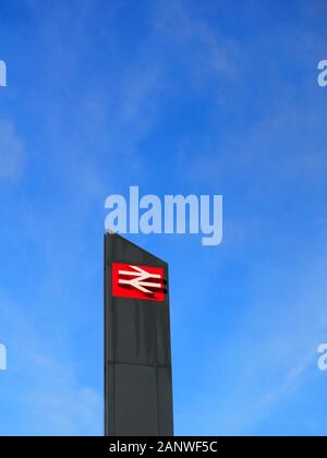 Railway Station Sign Featuring Double Arrow Logo, Northampton, UK Stock Photo