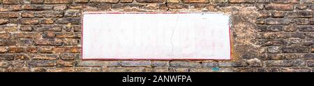 Blank white street sign board panel on brick wall Stock Photo
