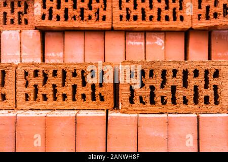 Pile of bricks texture wallpaper. Red bricks pile stacked for construction Stock Photo