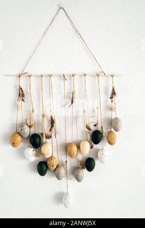 Hanging composition dream catcher of quail eggs and feathers Stock Photo