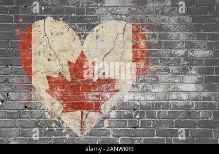 Grunge distressed heqart shaped flag of Canada painted on old weathered grey brick wall Stock Photo