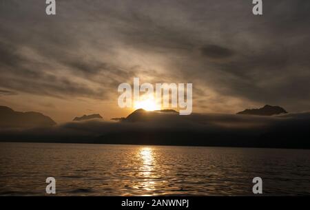 Sunrise over the mountains near the ocean in Alaska Stock Photo