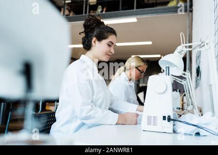 Women using sewing machines at factory Stock Photo