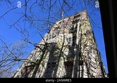 Old derelict mill from the industrial era. Old urban tower block housing and buildings concept Stock Photo