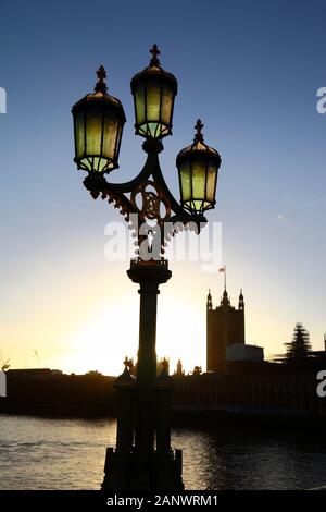 Ornate street lamp on Westminster Bridge, Victoria tower and Palace of Westminster / Houses of Parliamen in background, London, England Stock Photo