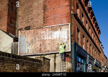 Man Working on a Billboard in Nottingham,UK. Stock Photo