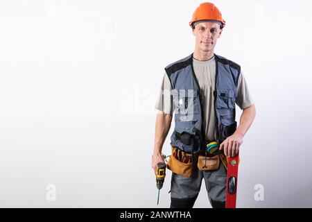 Builder with folded arms. In work clothes and hard hat. Stock Photo
