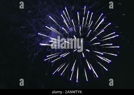 Blue bright fireworks against the dark sky. Stock Photo