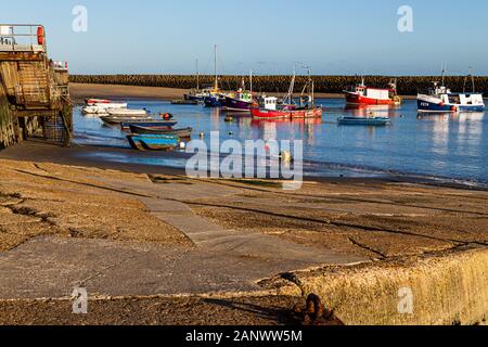 Folkestone, Kent. UK. Fishing Boats in Folkestone harbour in the late evening sun. Stock Photo