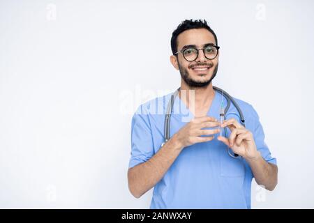 Happy young male clinician with toothy smile going to make injection Stock Photo