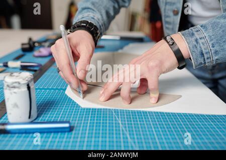 Using sewing patterns in leatherworking Stock Photo