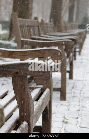Philadelphia, PA, USA - January 18, 2020: Snow begins to coat park benches in Rittenhouse Square during the city's first snowstorm of the year. Stock Photo