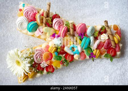 Birthdays, Valentine's Day cake. Birthday cake with coloured macarons(macaroon), chocolate, jelibon confections Stock Photo