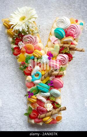 Birthdays, Valentine's Day cake. Birthday cake with coloured macarons(macaroon), chocolate, jelibon confections Stock Photo