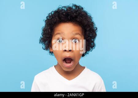 Wow, unbelievable! Portrait of funny amazed little boy looking at camera with shocked astonished expression, emotionally reacting to surprising news. Stock Photo