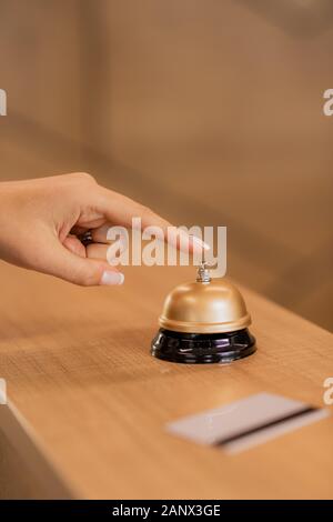 Hand of young contemporary businesswoman going to press call button on ring Stock Photo