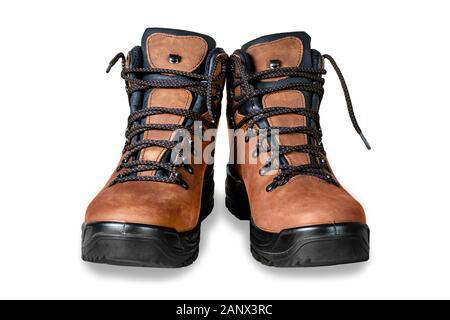 Pair of new modern high brown leather hiking boots isolated on white background. Two trekking rough warm winter footwear shoes. Male outdoor travel Stock Photo