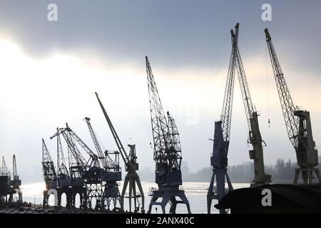 Cranes on the quayside of the River Schelde in Antwerp, Belgium, north Europe Stock Photo