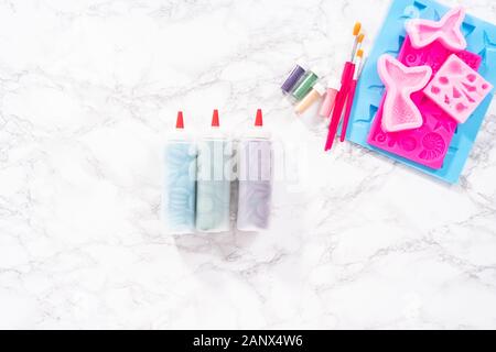 Flat lay. Ingredients to make chocolate mermaid molds from the chocolate chips. Stock Photo