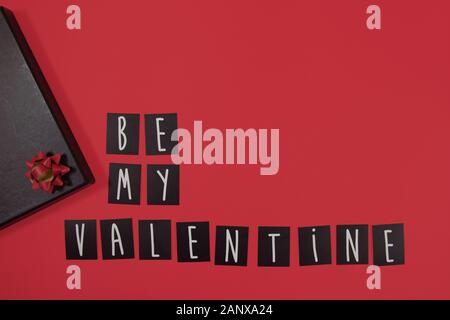 Phrase be my valentine made from letter words on red background. Valentines Day concept Stock Photo