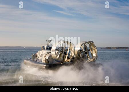 Island Flyer, a Hovertravel hovercraft leaving its terminal in Southsea, Portsmouth, Hampshire, south coast England to Ryde IOW in a cloud of spray Stock Photo