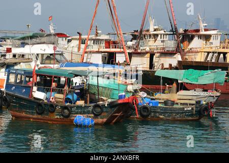 Small fishing boats are tied up in the safe harbor of the Shau Kei Wan Typhoon Shelter in the Quarry Bay District of Hong Kong. Stock Photo