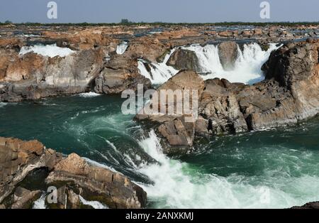 Sopheakmit or Preah Nimith waterfall, Islands with Brown Cliffs with Green rapids and large waterfalls in the Mekong River, Stung Treng, Cambodia Stock Photo