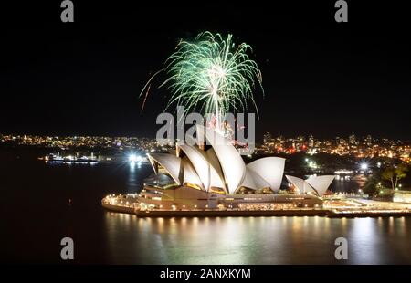 SYDNEY, AUSTRALIA - MARCH 8, 2018 - A shower of green fireworks spouts over the Sydney Opera House during a pyrotechnic show Stock Photo
