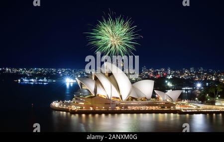 SYDNEY, AUSTRALIA - MARCH 8, 2018 - A big green ball of fireworks bursts against the night sky over the Sydney Opera House Stock Photo