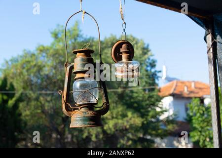 old gas lamp. rusted, hanging on the wall Stock Photo