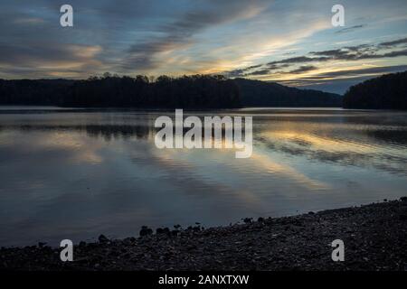 Sunrise, Lake Sidney Lanier. Symmetry between reflections and the sky at Wahoo Creek Park. Wahoo Creek Park is a recreation area on the north end of L Stock Photo